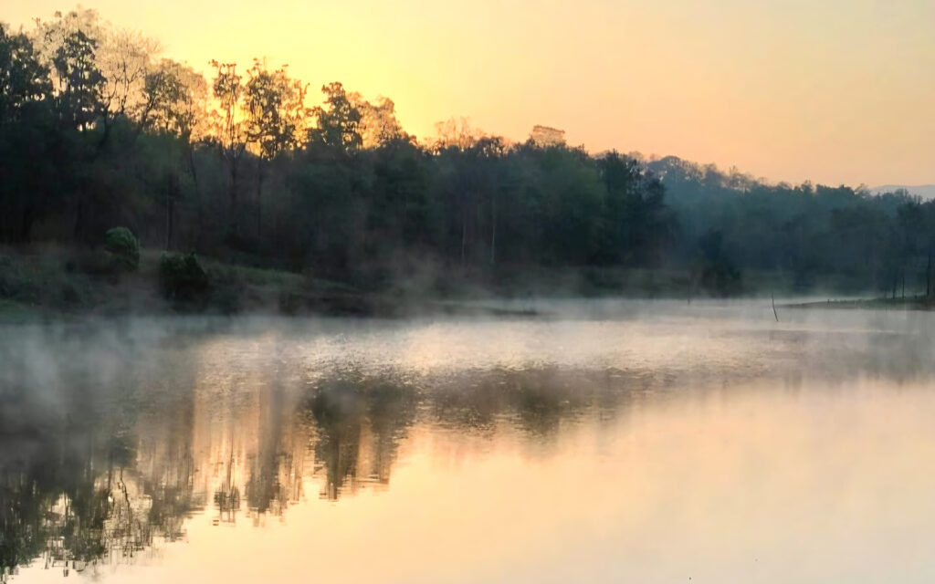 Sunrise over misty lake in Satpura Tiger Reserve Madhai region